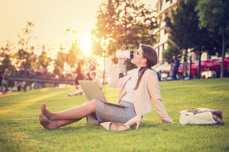 Attractive young business woman having a lunch breakの写真素材