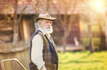 Senior farmer outside in beautiful summer natureの写真素材