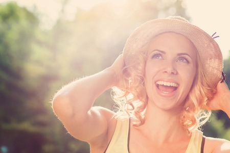 Attractive young woman outside in summer natureの写真素材