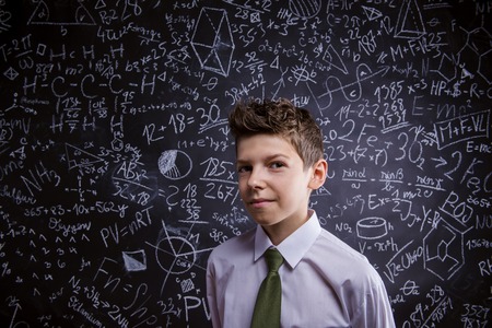 Young handsome student in front of big blackboard