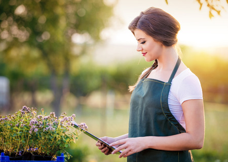 Young woman oustide in green nature gardeningの写真素材