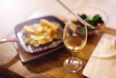 King prawns, vegetable salad and glass of wine laid on a table
