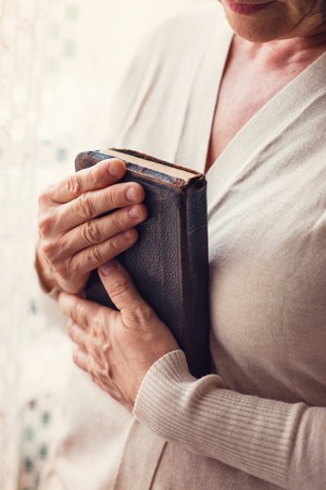 Unrecognizable woman holding a bible in her handsの写真素材