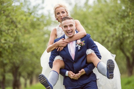 Beautiful young wedding couple outside in natureの写真素材