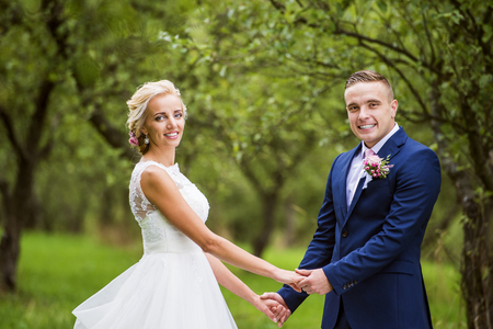 Beautiful young wedding couple outside in natureの写真素材