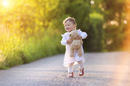 Cute little girl outside in nature on a summer dayの写真素材