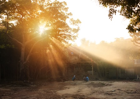Vietnamese children playing outside their house at the sunsetの写真素材