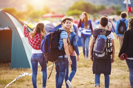 Group of beautiful teens arriving at summer festival