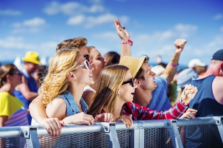 Group of beautiful teens at concert at summer festivalの写真素材