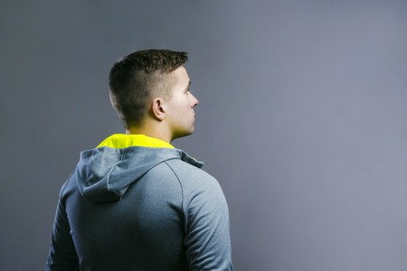 Handsome young runner. Studio shot on gray background.の写真素材