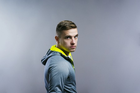 Handsome young runner. Studio shot on gray background.の写真素材