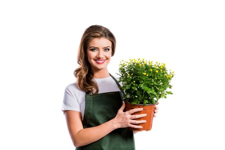 Beautiful young woman in mustard sweater. Studio shot on white background.の写真素材