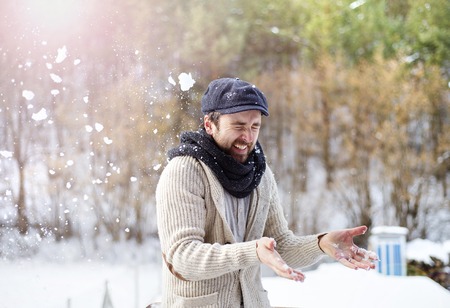 Handsome young man wearing woolen sweater in winter natureの写真素材