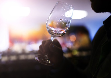 Unrecognizable young man enjoying a drink in a wine barの写真素材