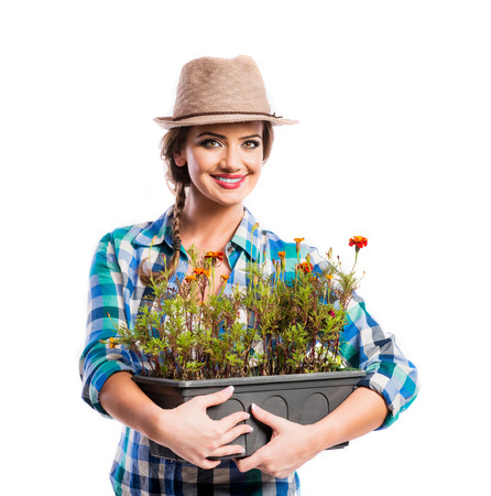Beautiful young woman with flowers. Studio shot on white background.の写真素材