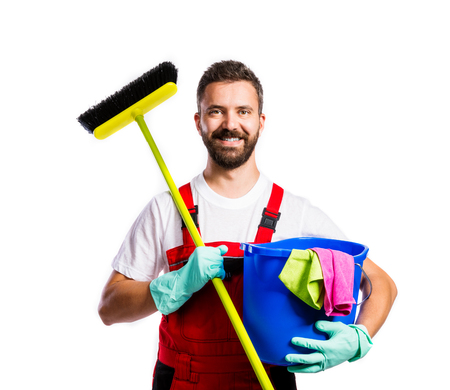 Young handsome cleaner in red overalls. Studio shot on white backgroundの写真素材