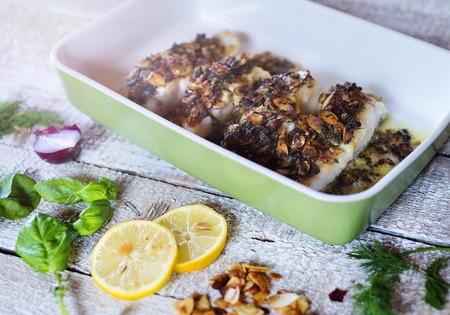 Zander fish fillets in green ceramic dishware
