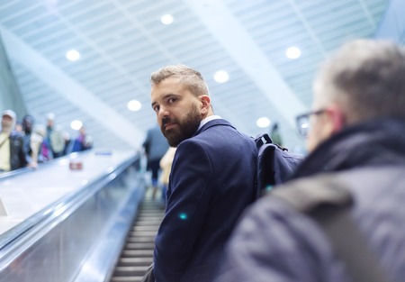 Young handsome businessman taking subway to workの写真素材