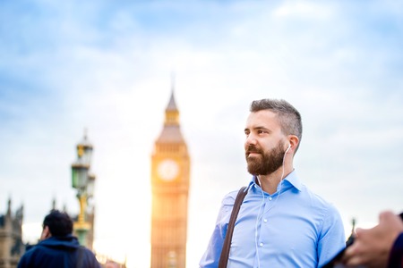 Handsome young man in blue shirt on Westminster bridge