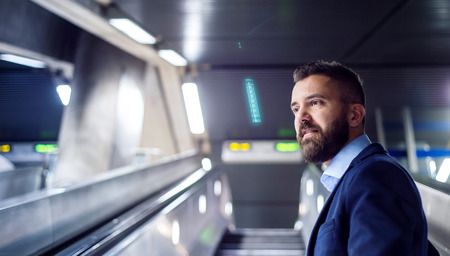 Young handsome businessman in subway on his way to work