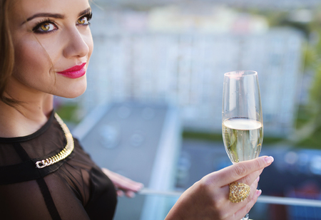 Attractive young woman with a drink on a terrace of a barの写真素材