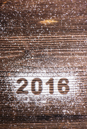 Happy new year composition. Studio shot on wooden background.