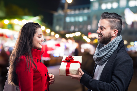 Young beautiful couple buying gifts in the cityの写真素材