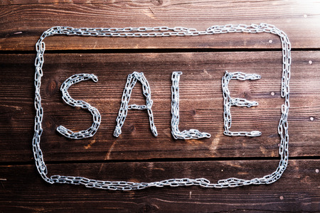 Sale composition. Studio shot on wooden background.