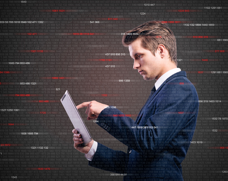 Double exposure of young handsome businessman with tablet.