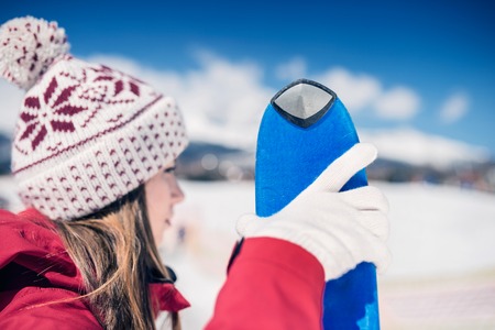 Young woman skiing outside in sunny winter mountainsの写真素材