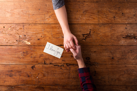 Valentines day composition. Studio shot on brown wooden background.の写真素材
