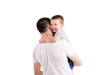 Happy young father with his son. Studio shot on gray background.の写真素材