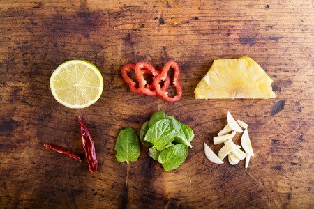 Various types of colorful fruit and vegetables laid on table. Studio shot on old wooden background.の写真素材
