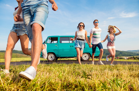 Young teenage couples in love running, boy and girl, boyfriend and girlfriend, outside in green...