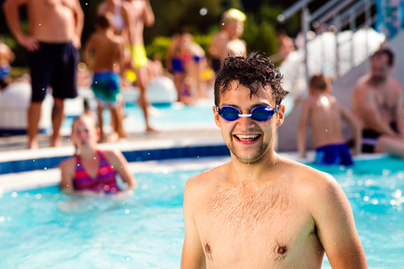 Man with goggles standing in the pool. Summer heat and water.の写真素材