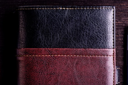 Close up of book laid on old wooden table, copy space. Studio shot on dark wooden background.の写真素材