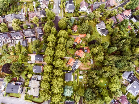 Aerial view of Dutch town, houses with gardens, green park with treesの写真素材