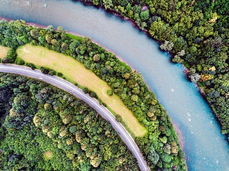 Aerial view of highway, river, forest and grassland during summer day. Slovakia.の写真素材