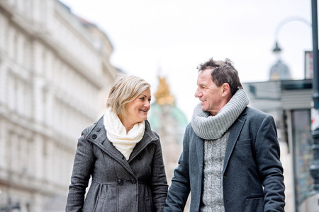 Beautiful senior couple on a walk in historical centre of the city of Vienna, Austria. Winter.の写真素材