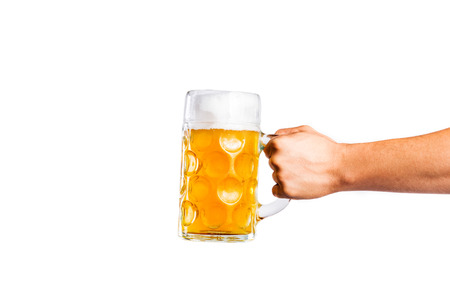 Hand of unrecognizable man holding a beer mug. Oktoberfest. Studio shot on white background, isolated. Copy space.の写真素材