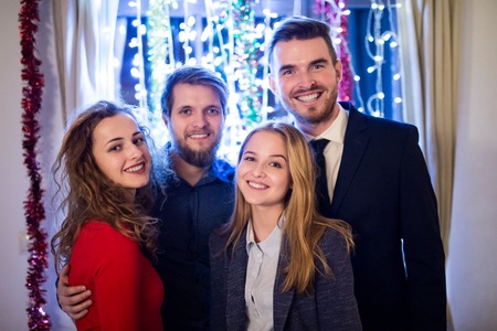 Group of friends celebrating the end of the year, having party on New Years Eve.の写真素材