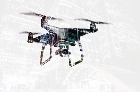 Double exposure. Hovering drone and city at night. Isolated.の写真素材
