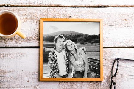 Black-and-white photo of seniors in picture frame. Studio shot.の写真素材
