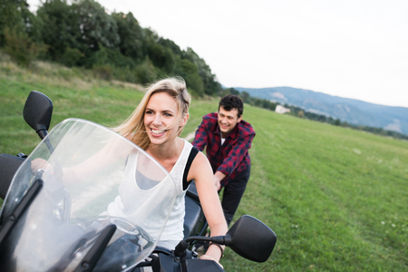 Couple in love enjoying a motorbike ride in countryside.の写真素材