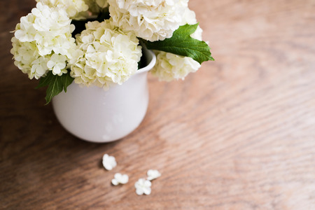 White lilac bouquet laid on wooden table. Studio shot.の写真素材