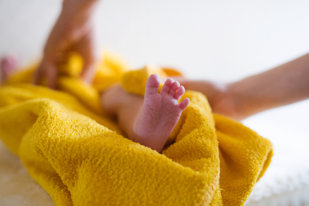 Unrecognizable mother drying her son with towel after a bathの写真素材