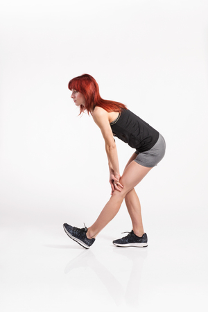Attractive young fitness woman in black tank top. Studio shot.の写真素材