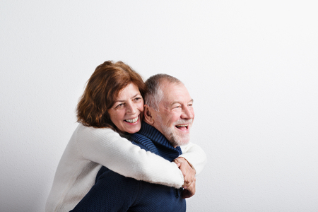 Beautiful senior couple in love hugging. Studio shot.の写真素材
