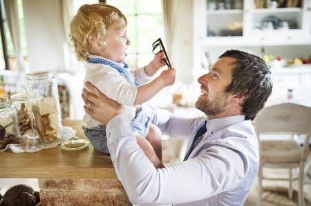 Young father at home with his son.