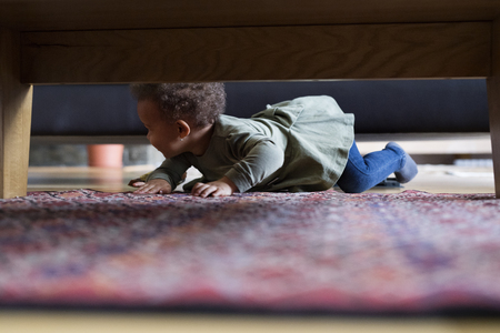 Little girl crawling at home.